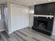 Living room with hardwood floors, fireplace, and double door closet at 5915 Winthrop Ave, Indianapolis, IN 46220