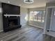 Living room features hardwood floors, fireplace, and sliding door leading to deck at 5915 Winthrop Ave, Indianapolis, IN 46220
