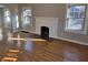 Sun-drenched living room showcasing a cozy fireplace and original hardwood floors at 5915 Winthrop Ave, Indianapolis, IN 46220
