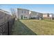 Backyard featuring grass, bare spots, a wood fence and a metal chain-link fence at 6663 Black Antler Cir, Indianapolis, IN 46217