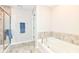 Bright bathroom featuring a tub, stand-up shower, and neutral tile work at 698 Ridge Gate Dr, Brownsburg, IN 46112