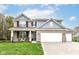 Charming two-story home with brick facade, attached garage, and well-manicured lawn at 698 Ridge Gate Dr, Brownsburg, IN 46112