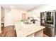 Modern kitchen with stainless steel refrigerator and a granite topped island with sink at 698 Ridge Gate Dr, Brownsburg, IN 46112