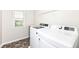 Bright laundry room featuring modern white washer and dryer units with a window for natural light at 698 Ridge Gate Dr, Brownsburg, IN 46112