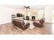 Cozy living room with fireplace, ceiling fan, and hard wood floors at 698 Ridge Gate Dr, Brownsburg, IN 46112