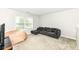 Comfortable living room with a large sofa, soft carpet, and a window offering natural light at 698 Ridge Gate Dr, Brownsburg, IN 46112