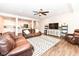 Open-concept living room and kitchen with hardwood floors and modern decor at 698 Ridge Gate Dr, Brownsburg, IN 46112