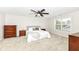 Bright main bedroom with ceiling fan, carpet, large window, and ample space for furniture at 698 Ridge Gate Dr, Brownsburg, IN 46112