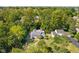 Aerial view of the home among lush trees, complemented by a well-manicured yard and driveway at 6980 N Pennsylvania St, Indianapolis, IN 46220