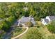 Aerial view of the home with lush yard and mature trees, showcasing its landscaping at 6980 N Pennsylvania St, Indianapolis, IN 46220