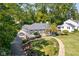 Scenic aerial view of a beautiful home with a lush green lawn and curved walkway at 6980 N Pennsylvania St, Indianapolis, IN 46220