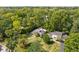 Aerial view of the home and surrounding property, featuring manicured lawns and mature trees at 6980 N Pennsylvania St, Indianapolis, IN 46220