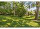 Lush backyard featuring manicured lawn and mature trees offering shade and privacy at 6980 N Pennsylvania St, Indianapolis, IN 46220
