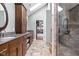 Spa-like bathroom with custom vanity, stone shower, and direct access to walk-in closet at 6980 N Pennsylvania St, Indianapolis, IN 46220