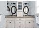 Bathroom with dual sinks, granite countertops, and white cabinets at 6980 N Pennsylvania St, Indianapolis, IN 46220