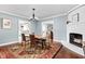 Elegant dining room with a rustic table, a modern chandelier, and views into the living spaces at 6980 N Pennsylvania St, Indianapolis, IN 46220