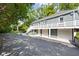 A large home with a long driveway and a three-car garage, all surrounded by lush trees at 6980 N Pennsylvania St, Indianapolis, IN 46220