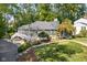 Charming home with a white fence, landscaped yard, and lush greenery, creating a serene and inviting curb appeal at 6980 N Pennsylvania St, Indianapolis, IN 46220