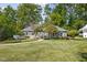 Charming home with a well-manicured lawn, walkway, mature trees, and picturesque curb appeal at 6980 N Pennsylvania St, Indianapolis, IN 46220