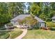 Well-maintained front yard featuring lush greenery and mature trees, complemented by a charming walkway at 6980 N Pennsylvania St, Indianapolis, IN 46220