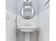 Chic half bathroom featuring a pedestal sink, subway tile, and a round mirror at 6980 N Pennsylvania St, Indianapolis, IN 46220