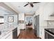 Kitchen with stainless steel appliances, white cabinets, and hardwood flooring at 6980 N Pennsylvania St, Indianapolis, IN 46220
