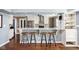 Kitchen with bar-top island with granite countertop and seating for four at 6980 N Pennsylvania St, Indianapolis, IN 46220