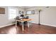 Bright home office with a large window, a white table, and hardwood floors at 6980 N Pennsylvania St, Indianapolis, IN 46220