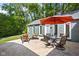 Relaxing outdoor patio with a glass top table, comfortable seating and retractable umbrella at 6980 N Pennsylvania St, Indianapolis, IN 46220