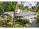 The backyard of the home has lush greenery, a brick patio area, and stairs leading to a deck at 6980 N Pennsylvania St, Indianapolis, IN 46220