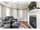 Bright sitting room with a fireplace, comfortable seating, and large windows for natural light at 6980 N Pennsylvania St, Indianapolis, IN 46220