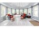 Bright sunroom with tiled floors, white windows, and comfortable seating at 6980 N Pennsylvania St, Indianapolis, IN 46220