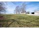 Lovely, expansive backyard with a view of the home and a metal outbuilding on the right at 712 N Pendleton Ave, Pendleton, IN 46064