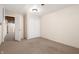 Spacious basement featuring carpeted floors, ample storage, and a door leading to the utility area at 712 N Pendleton Ave, Pendleton, IN 46064