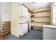 Functional utility room featuring white cabinets and open shelving, providing ample storage solutions for household essentials at 712 N Pendleton Ave, Pendleton, IN 46064