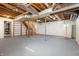Large unfinished basement with exposed ductwork and plumbing, offering potential for customization and added living space at 712 N Pendleton Ave, Pendleton, IN 46064