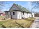 Charming home featuring green roof, siding, and inviting wooden deck in a serene outdoor setting at 712 N Pendleton Ave, Pendleton, IN 46064