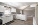 Bright kitchen with stainless steel appliances, white cabinets, and a spacious breakfast bar that adjoins the dining room at 712 N Pendleton Ave, Pendleton, IN 46064