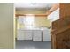 Bright laundry room featuring a washer, dryer, cabinetry, countertop, and ample storage space at 712 N Pendleton Ave, Pendleton, IN 46064