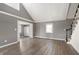 Open living room with wood floors, large windows, and staircase to the second floor at 712 N Pendleton Ave, Pendleton, IN 46064