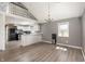 Inviting living space with a breakfast bar, wood floors, and views into the kitchen at 712 N Pendleton Ave, Pendleton, IN 46064