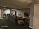 Spacious basement with gray walls, dark carpet, a comfortable sectional couch, and stylish decor at 720 Erin Dr, Avon, IN 46123