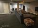 Open basement area with gray walls, dark carpeting, comfortable seating, and ample space at 720 Erin Dr, Avon, IN 46123