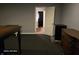 Unfinished basement space with dark carpet, gray walls, offering storage potential and access to a bathroom at 720 Erin Dr, Avon, IN 46123