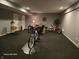 Functional basement space with gray walls, dark carpeting, offering potential for various activities and storage at 720 Erin Dr, Avon, IN 46123