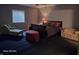 Comfortable bedroom featuring a bed, chaise lounge, patterned sofa, and window with blinds at 720 Erin Dr, Avon, IN 46123