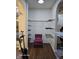 Walk-in closet with chair and custom shelving for optimal organization and a stylish design at 720 Erin Dr, Avon, IN 46123