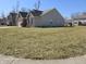 Spacious yard surrounding a well-maintained home exterior, offering ample outdoor space at 720 Erin Dr, Avon, IN 46123
