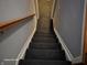 Carpeted staircase ascends, framed by gray walls and a light wood handrail at 720 Erin Dr, Avon, IN 46123