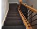 Carpeted staircase with decorative black iron railing and wood handrail leads to the next level at 720 Erin Dr, Avon, IN 46123